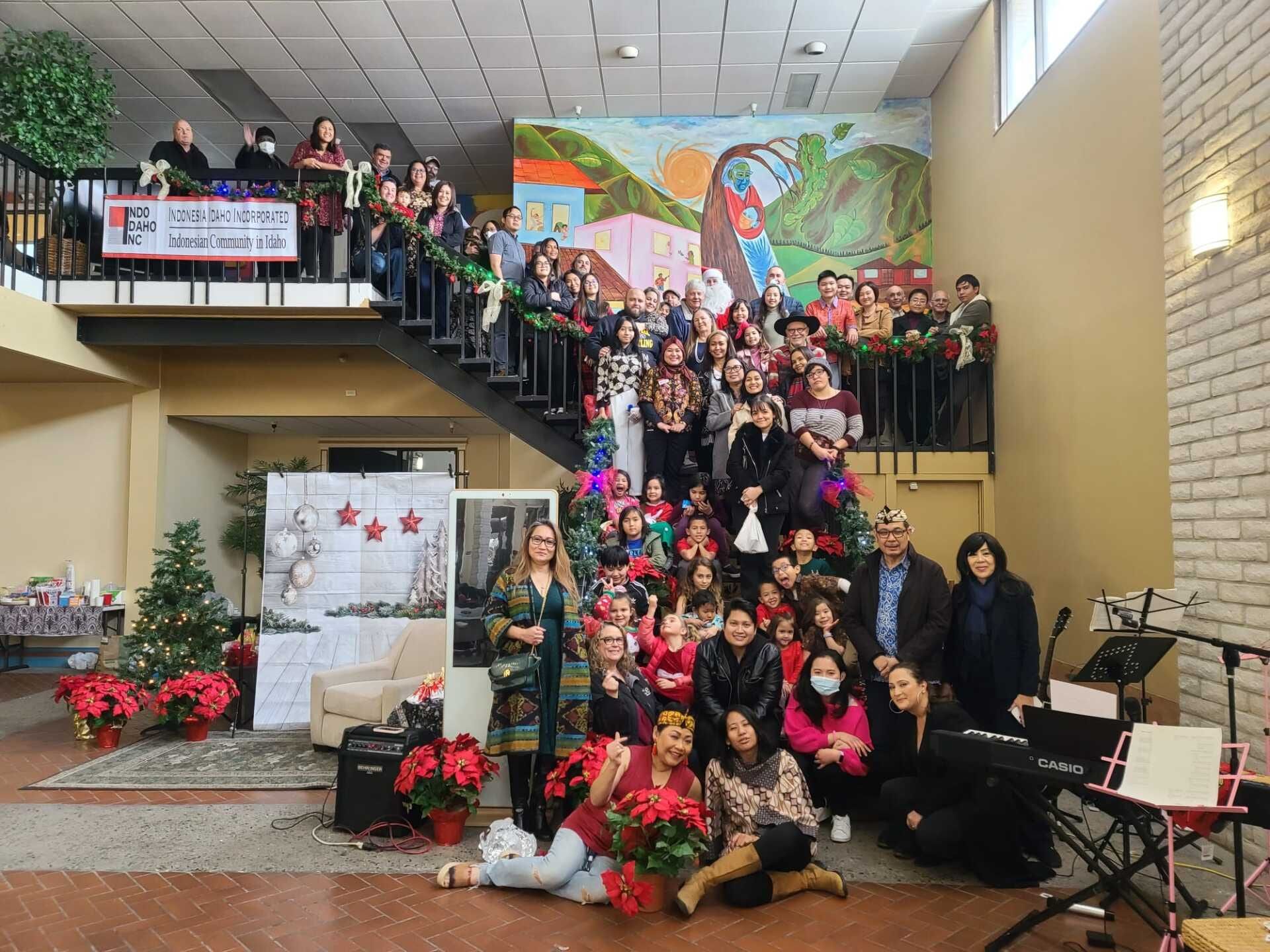 Members of the Indonesian community in Idaho gathered on a decorated staircase at an Indo Idaho event